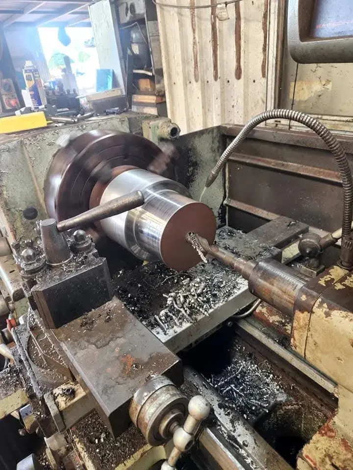 Lathe turning a large steel shaft