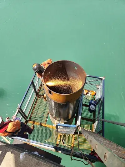 Marine pile welding aerial sparks