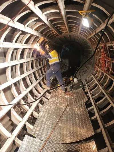 Confined space welding inside mine drum