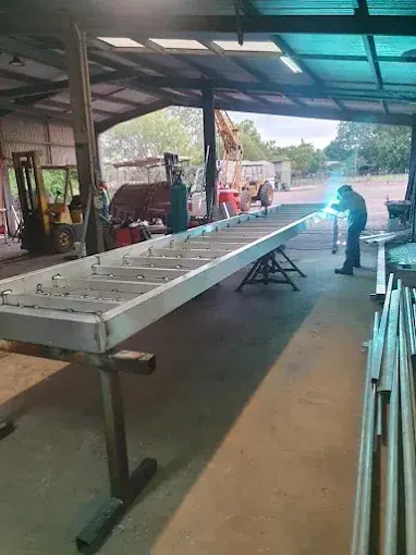 Welder fabricating a steel frame in the workshop